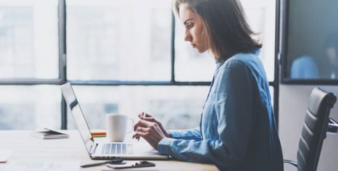 Woman at laptop keyboard